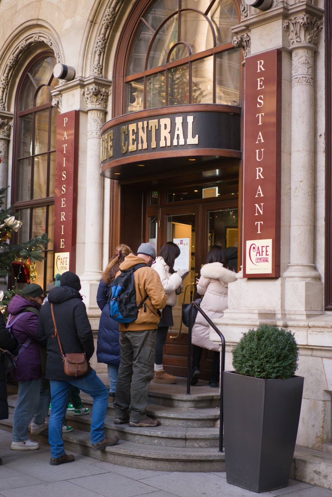 Visitors queuing at the entrance of Café Central in Vienna