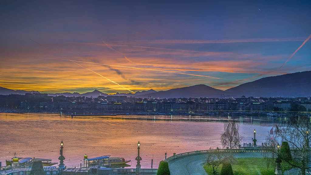Sunset over Lake Geneva with mountains on the horizon