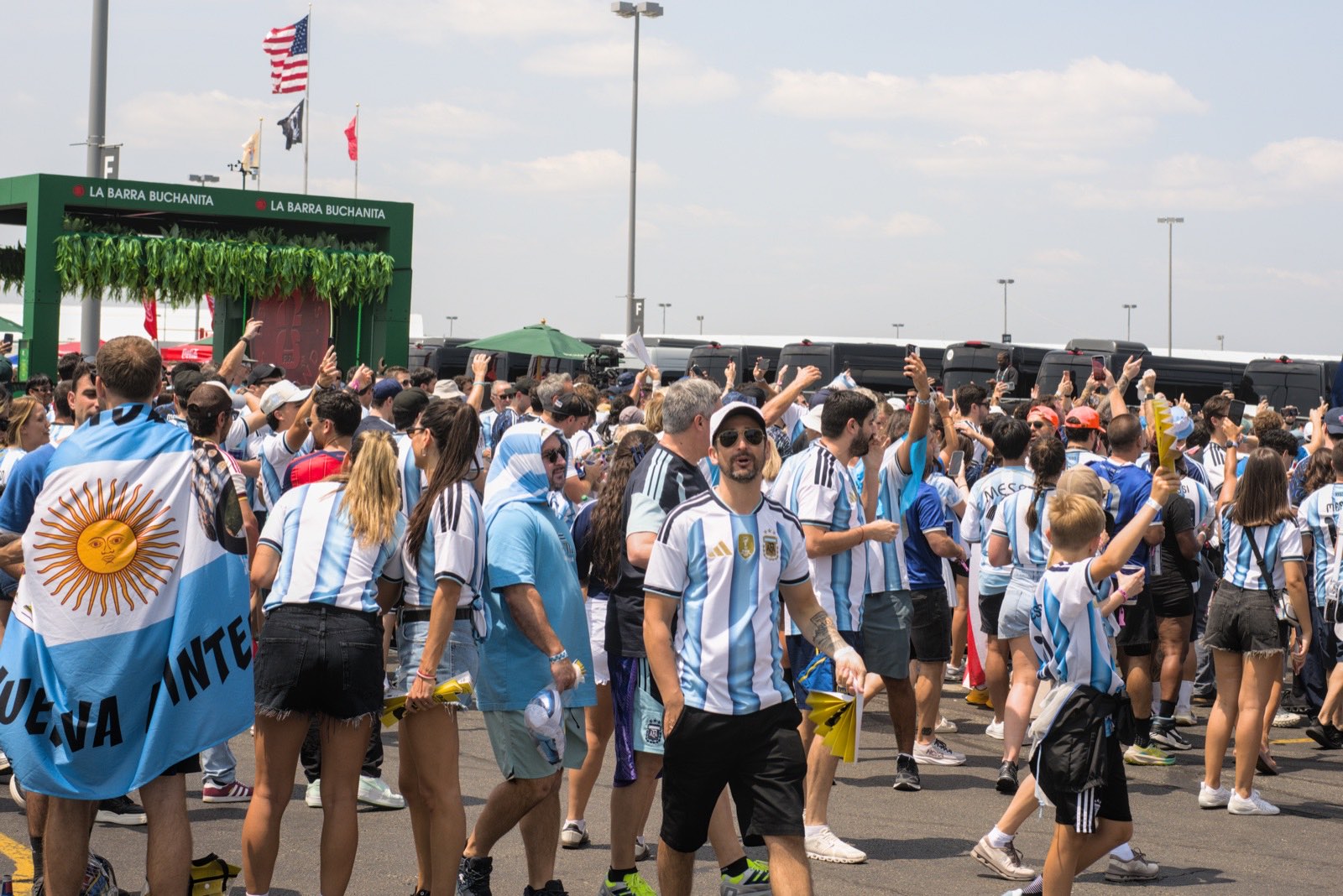 A crowd of Argentina supporters with flags outside the stadium