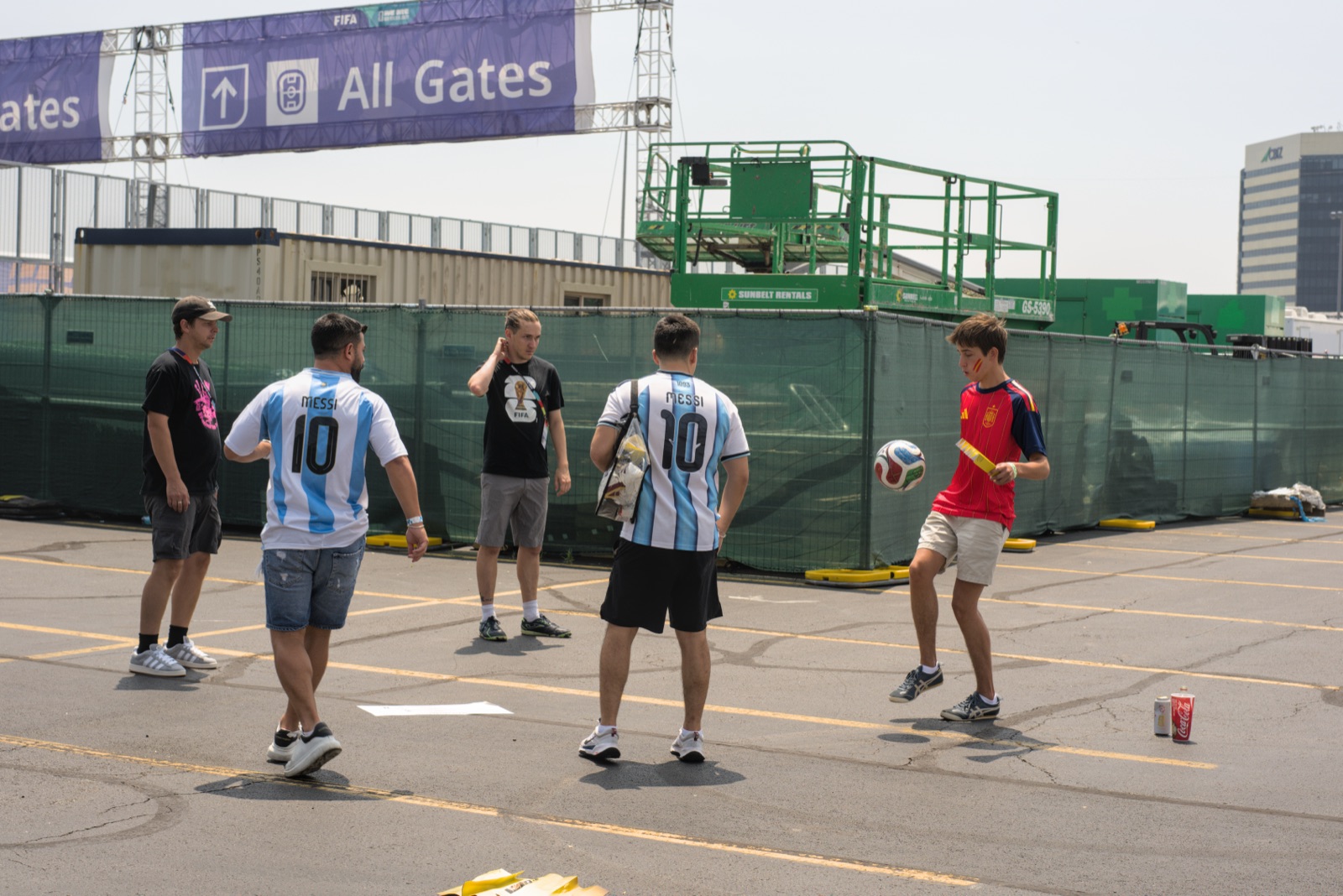Fans juggling a football outside the stadium gates